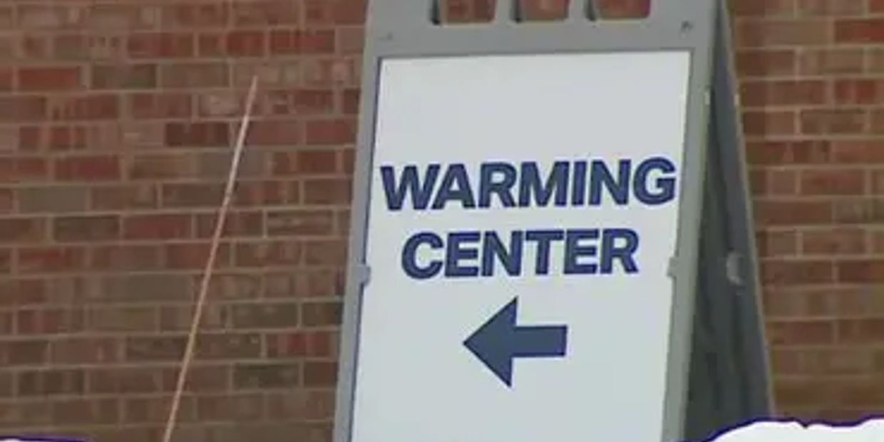 Sign indicating direction to a warming center.
