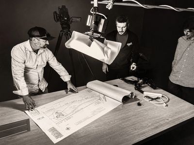 Dan Honig reviewing construction plans during a business filming session.
