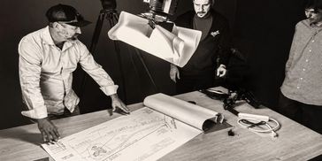 Dan Honig reviewing construction plans during a filmed work session.