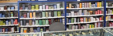 A wall of shelves filled with colorful film canisters behind a counter.