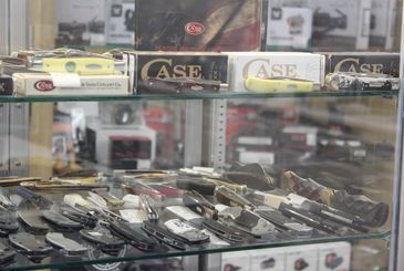 Display case with various folding knives and knife boxes.