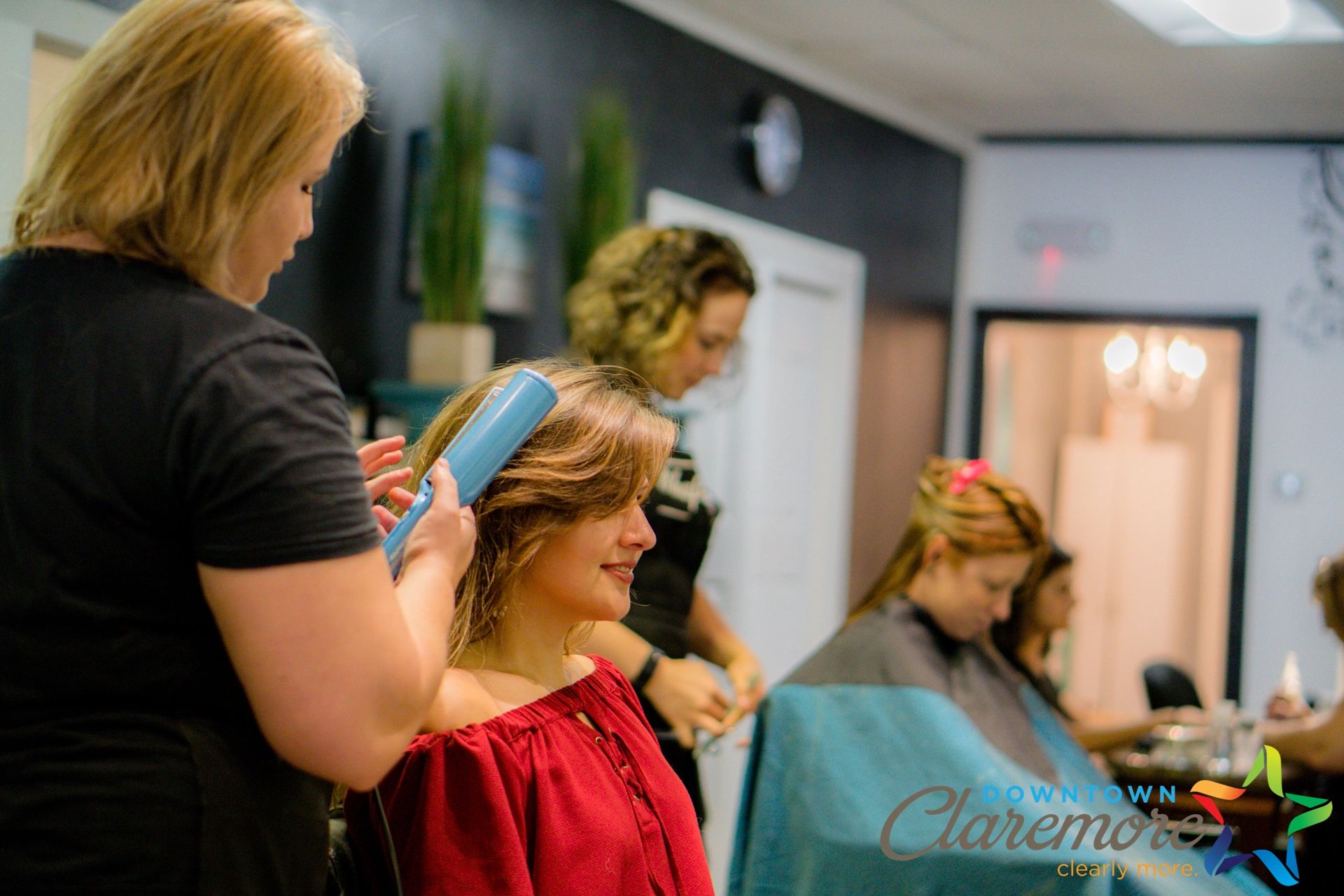 Hair stylists at Rhapsody Salon and Spa styling hair.