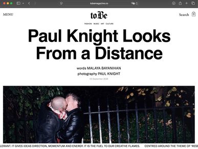Article titled 'Paul Knight Looks From a Distance' with a photo of two people kissing.