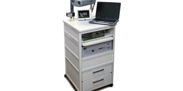 A white medical equipment cart with electronic devices and a laptop.