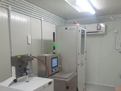 Industrial machinery in a clean, enclosed room.