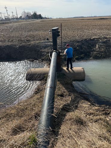 Example of a tank mounted vertical pump in a ditch.  Tank has a ledge to limit debris.