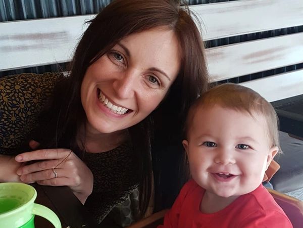 Mom and baby smiling in a restaurant