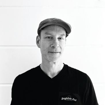 Man wearing a cap and Brightside Deli shirt.