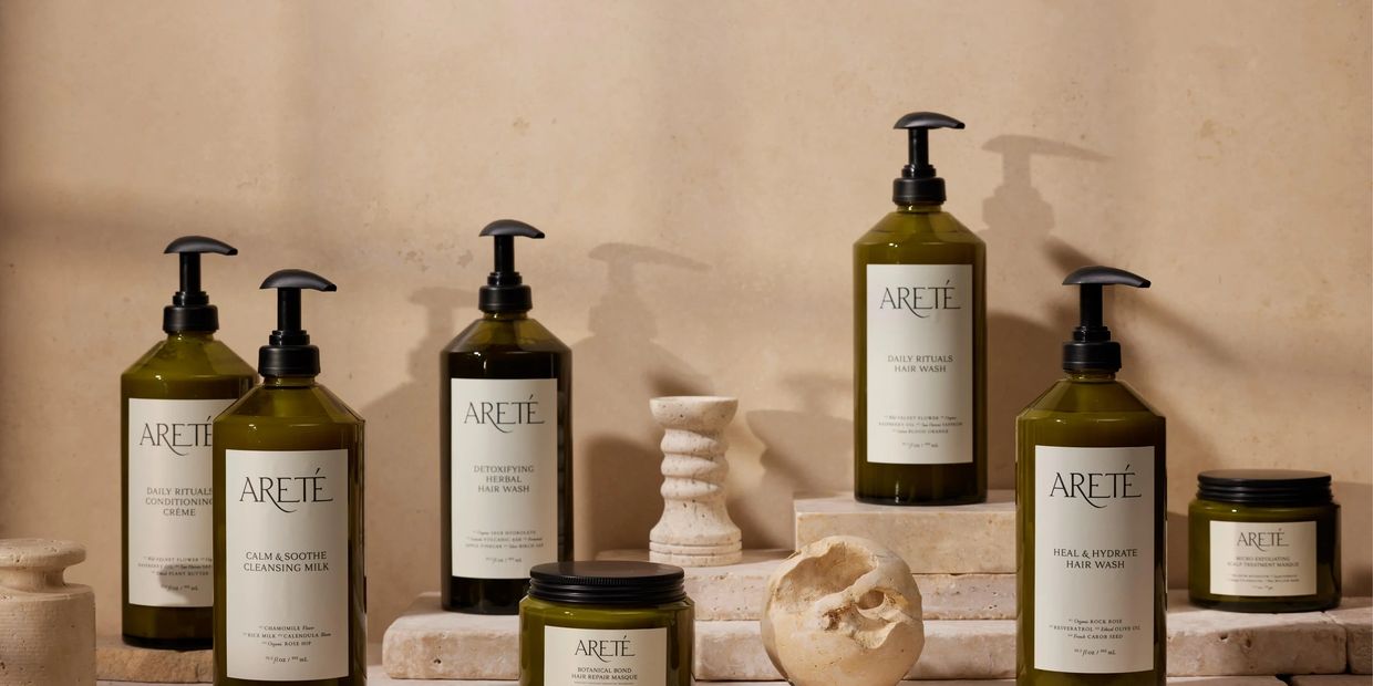 Elegant Arete skincare products displayed with natural stone decor.