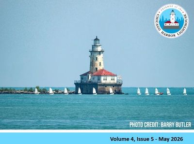Chicago Harbor Lighthouse stands amidst calm waters with small sailboats nearby.
