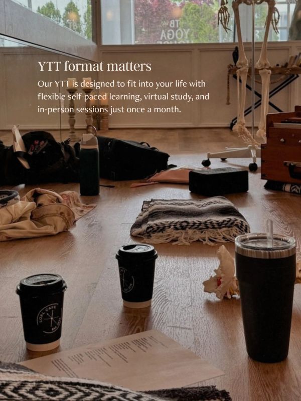 Yoga studio with coffee cups and folded blankets on the floor.