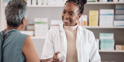 Pharmacist assisting a patient with medication at a local pharmacy in Philadelphia.