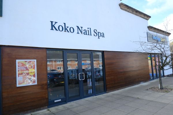 Exterior view of Koko Nail Spa with glass doors and wooden paneling.