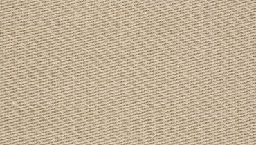Close-up of beige textured fabric with diagonal weave.