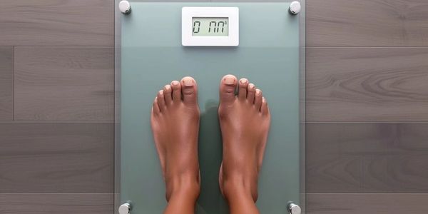 Feet on scale for measuring weight