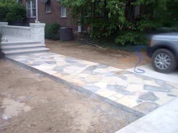 Newly installed stone walkway leading to house steps.