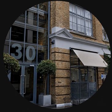 Building entrance with large number 30 on glass door.