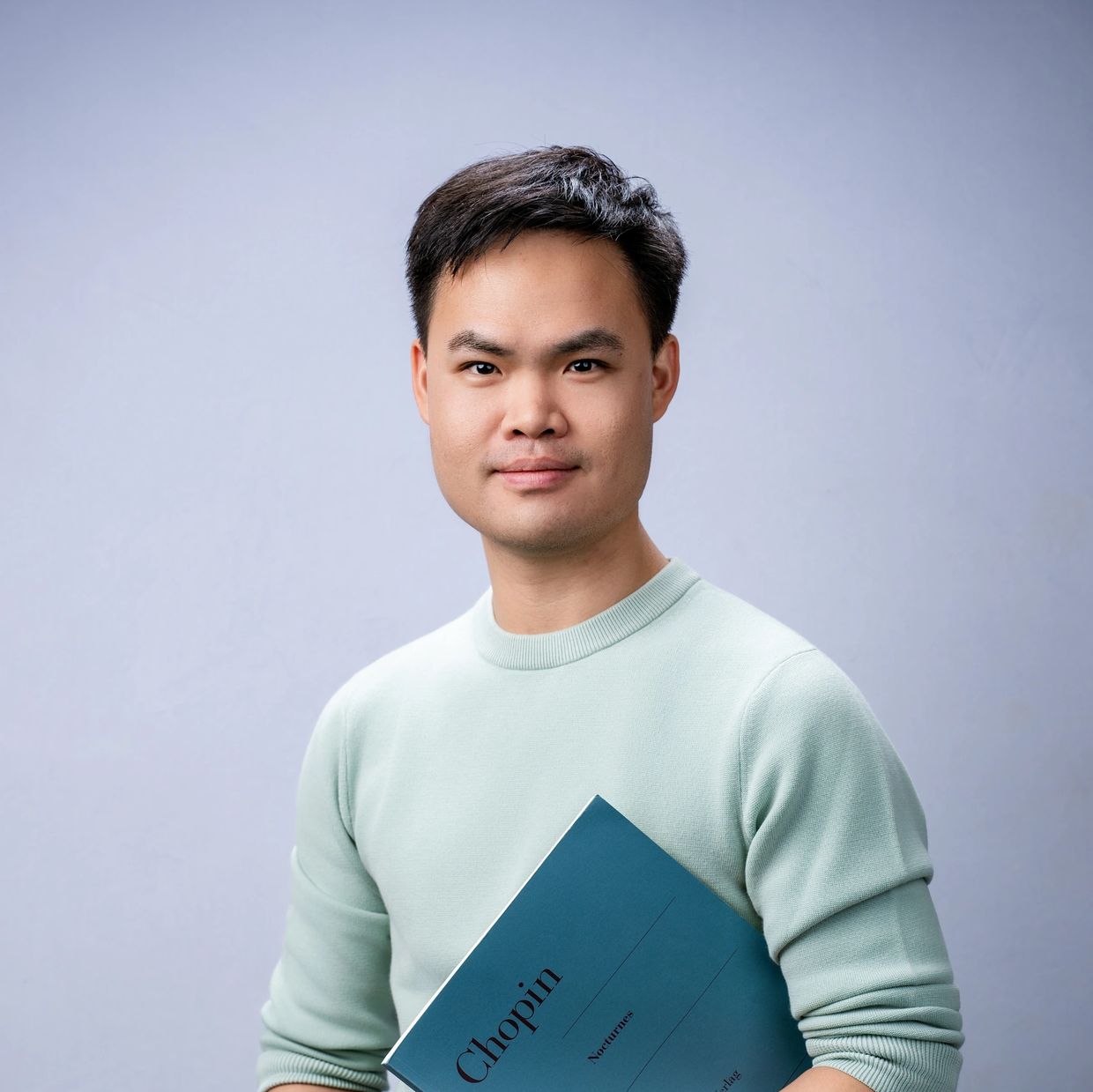 Man holding a Chopin music book.