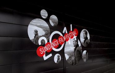 Side of a building with circle cutouts of a movie and the festival name/year.