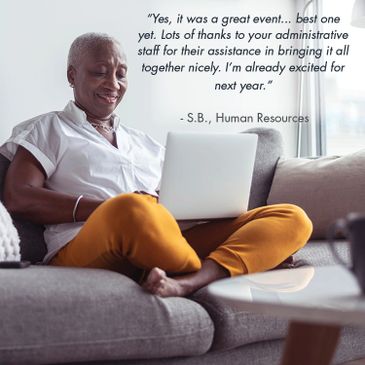Smiling woman praises administrative staff for a successful event while using a laptop.