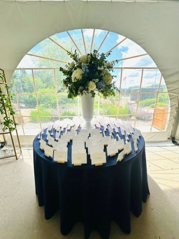 Round table with name cards and a floral centerpiece.
