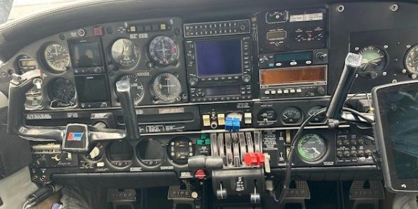 Cockpit control panel with various instruments and controls.
