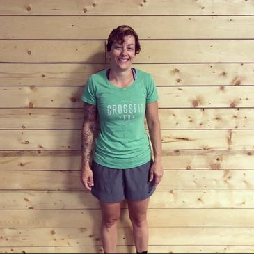 Headshot of a woman in a green CrossFit D10 shirt