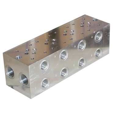Metal hydraulic manifold block with multiple threaded ports.