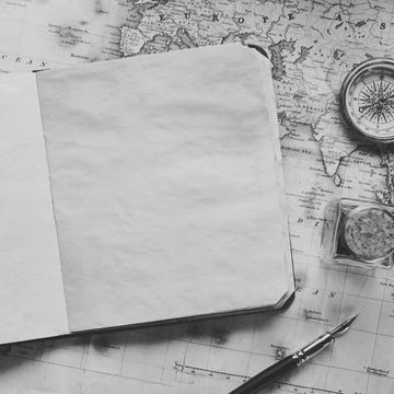 black and white picture of a blank notebook on a map