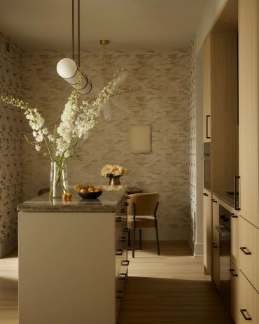Modern kitchen with a wooden finish and floral decorations.
