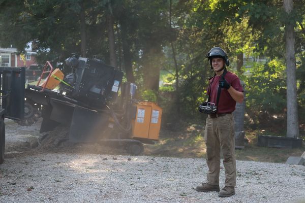 Man operating machinery remotely at a construction site.