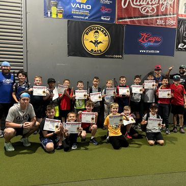 A group of youth baseball players holding certificates