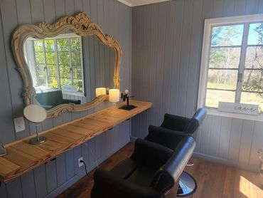 Hair and makeup room, barber chairs, vintage mirror and original vintage windows, natural light