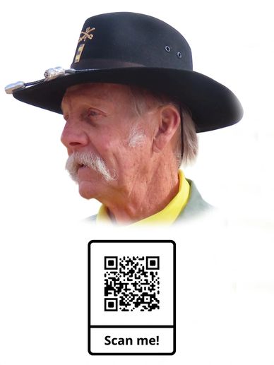 Profile of an elderly man wearing a black hat and yellow shirt.