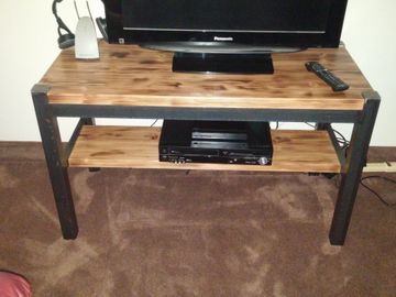 Industrial basic TV stand for small apartment space made from unfinished steel and reclaimed wood