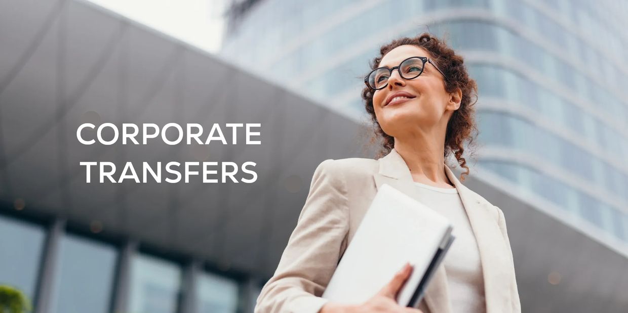 Businesswoman in front of office building with words 'CORPORATE TRANSFERS'