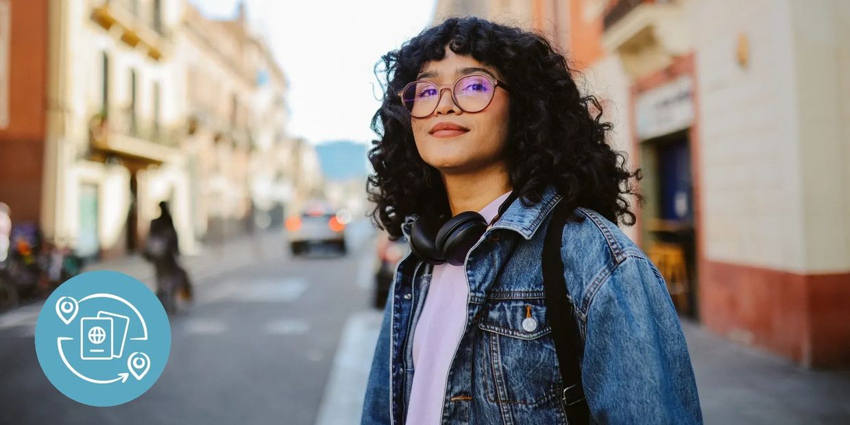 Confident young woman with headphones on a European street