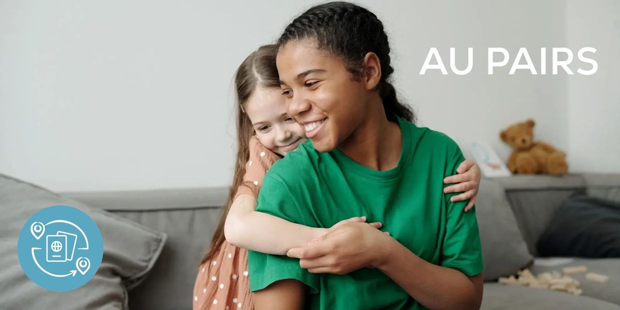 A young woman and a younger girl smile and hug with the words 'AU PAIRS'