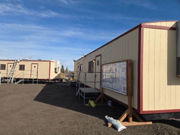 Temporary modular buildings under a blue sky.