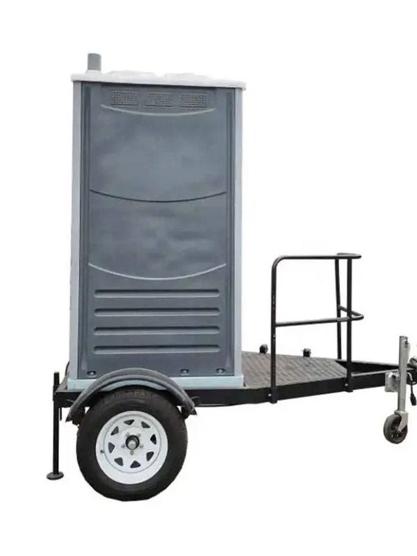 Portable toilet on a trailer platform.