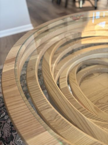 Close-up of a wooden table with a glass top.