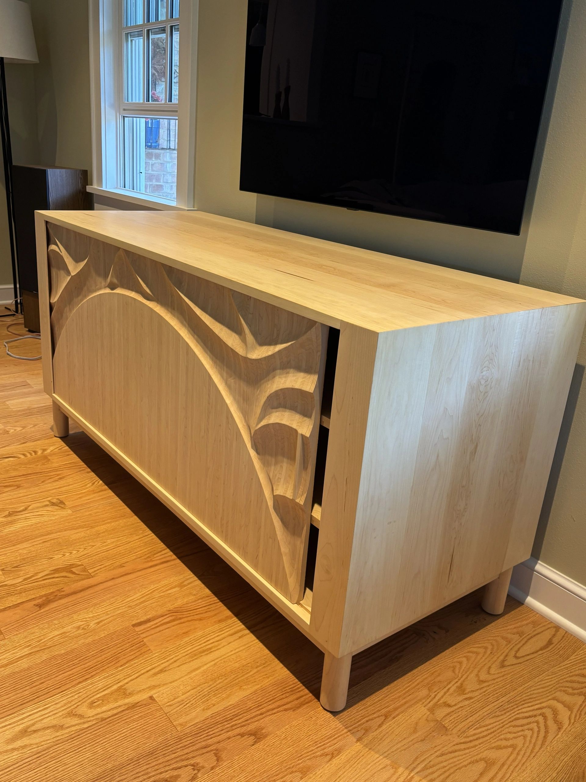 Wooden cabinet with intricate carved patterns.