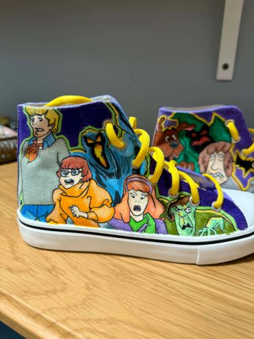 Custom Scooby-Doo themed sneakers with yellow laces.