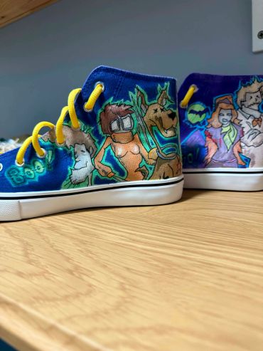 Custom Scooby-Doo themed sneakers with bright yellow laces.