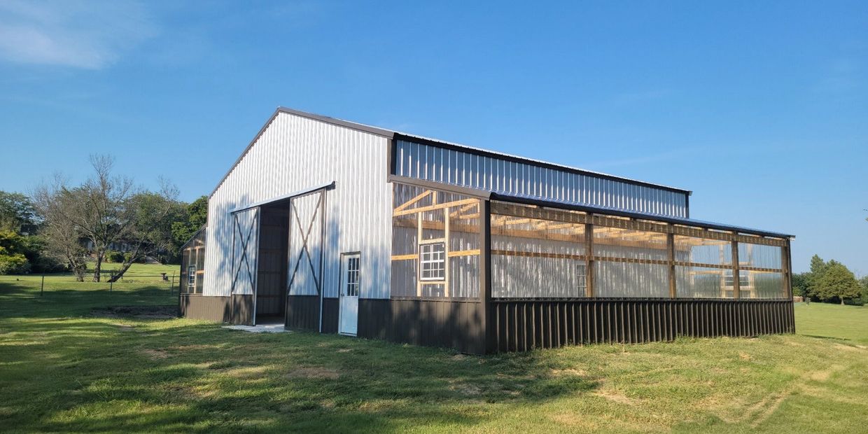 Winslow's cutom pole barn with greenhouses on each side.