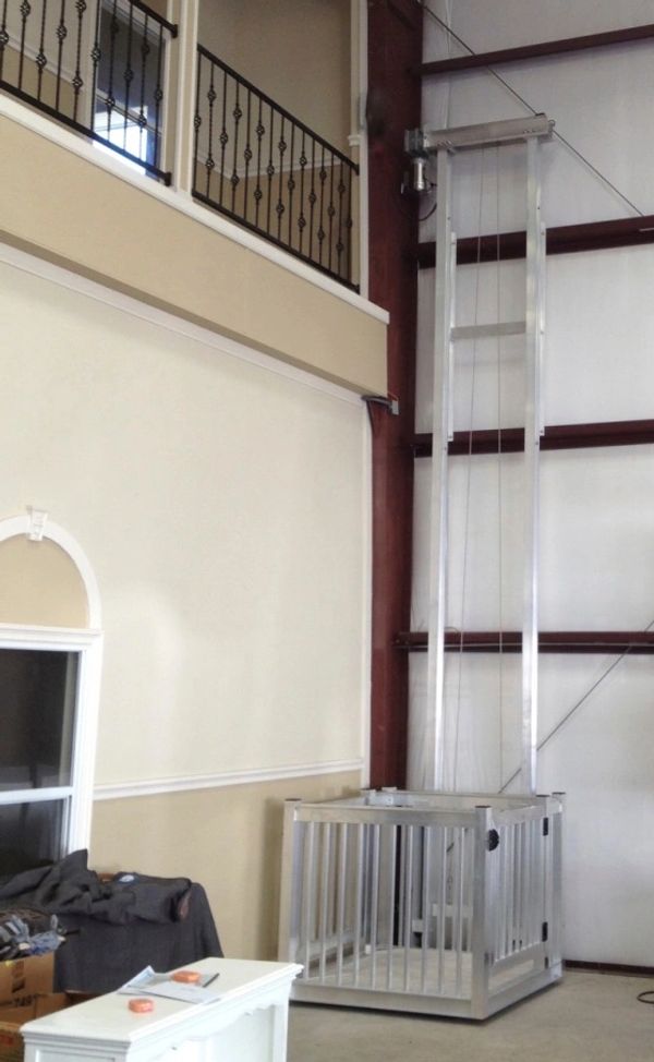 Residential cargo and freight lift installed indoors for multi level use.