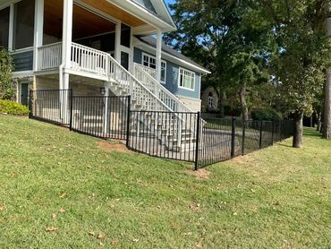 Installation of wrought iron privacy fencing at a lakefront home in Tyler Texas