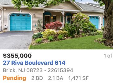 House with blue garage doors and front porch in Brick, NJ.