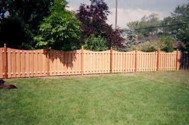 Welcoming wood fence gate with a house in the background