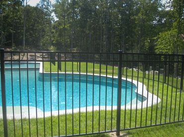 Contemporary black aluminum gate installed at a home entrance.